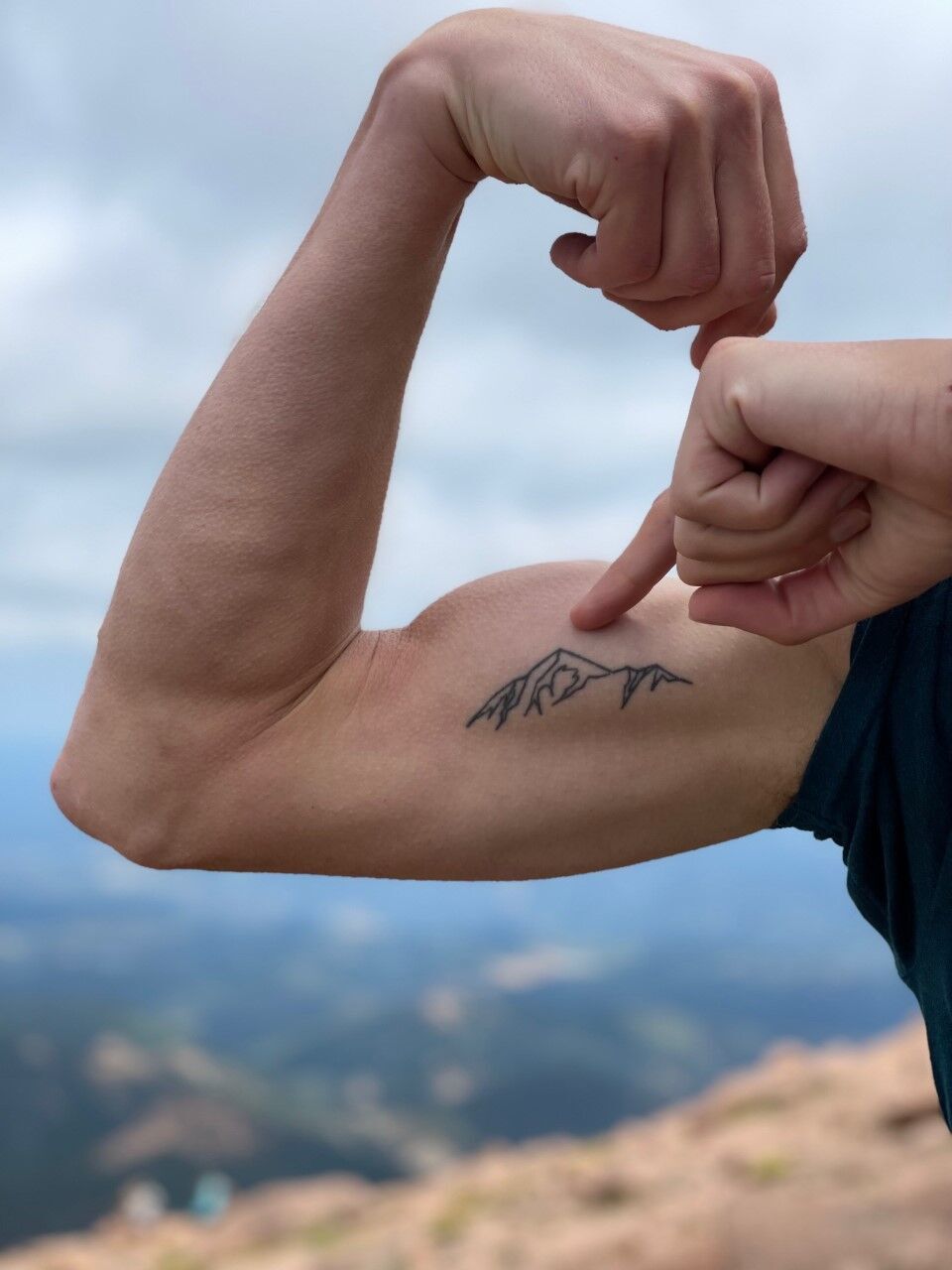 A minimalist mountain in a circle tattoo on the left bicep | Circle tattoo,  Circle tattoos, Tattoos for guys